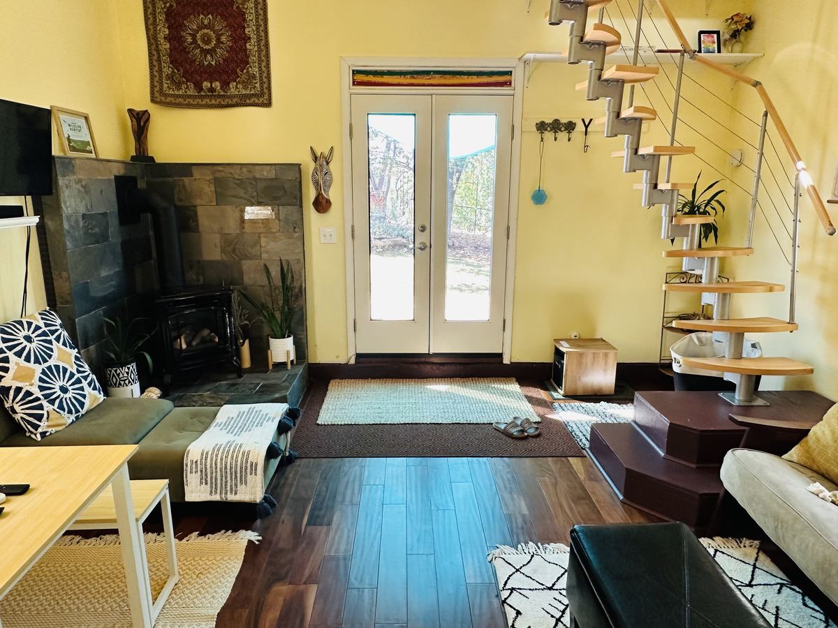 The cottage living room with a wood stove and French doors