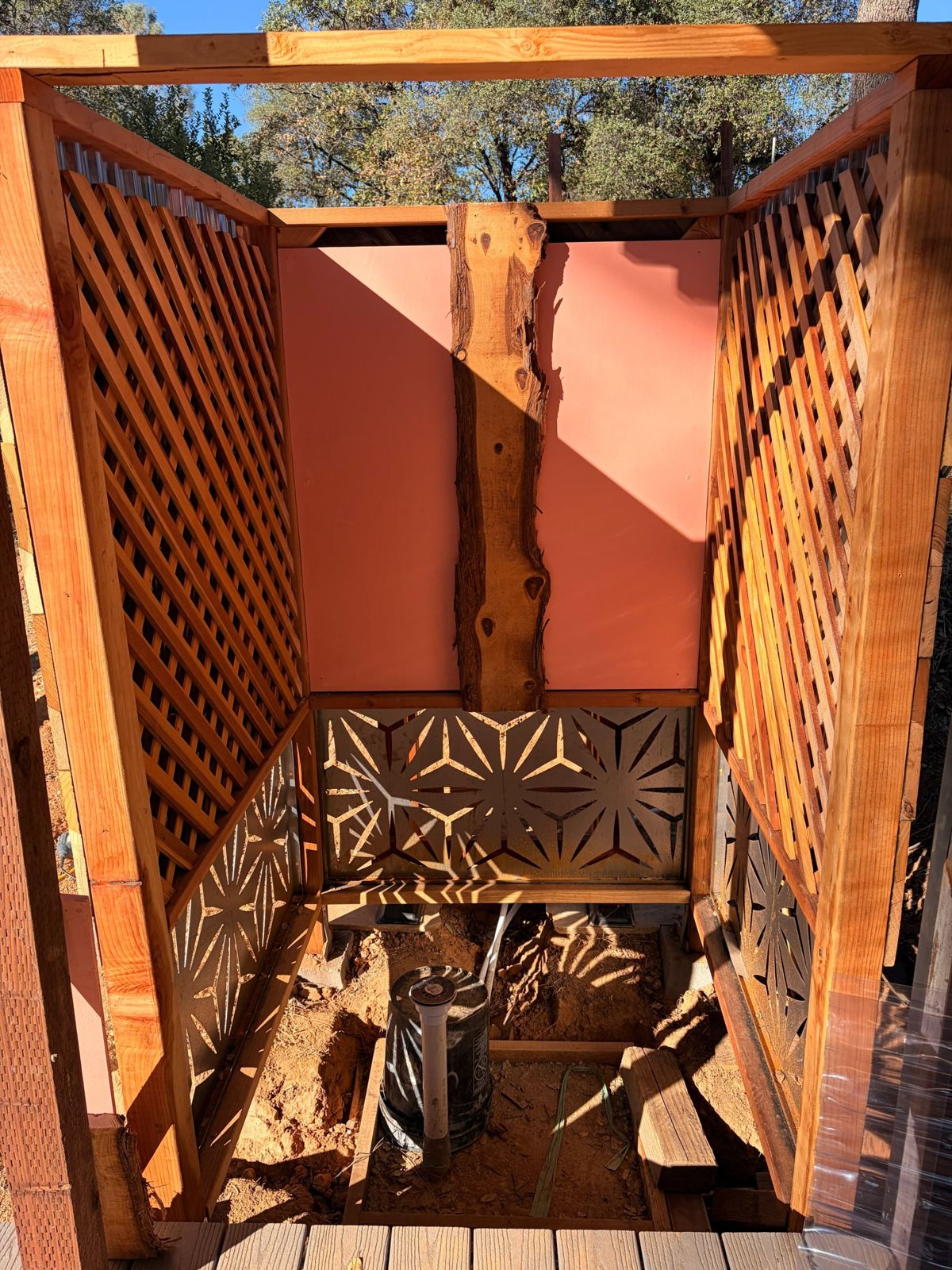 The cedar and lattice wellness enclosure with a terracotta wall