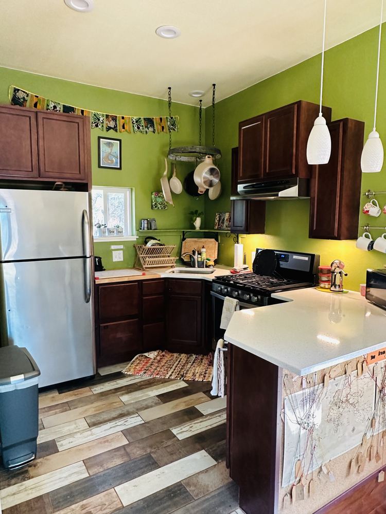 Green kitchen with wood cabinets